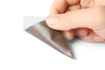 Woman putting sticking plaster on white background. First aid item