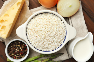 Flat lay composition with different ingredients on wooden table. Risotto recipe