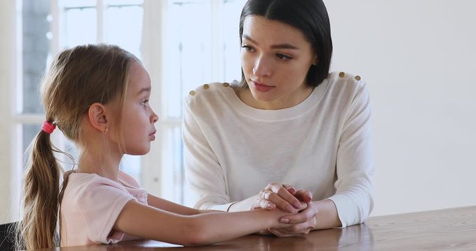 Caring mother psychologist comforting sad kid girl help with problem