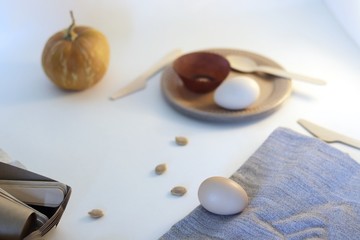 Disposable dishes, made from natural materials, fresh eggs on a light background, environmental cleanliness, healthy lifestyle