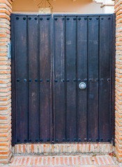 Gate entrance door to land in house in Spain. Typical wooden door design in Andalucia