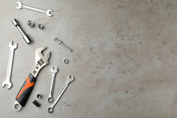 Auto mechanic's tools on grey background, flat lay. Space for text