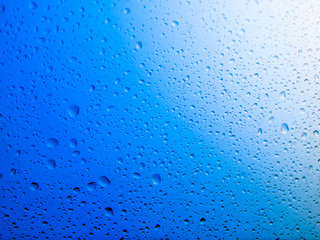 water drops on glass background.Blue water drops on mirror background.
