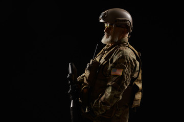 Old military officer holding sniper rifle.