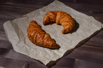 fresh croissants on wooden background