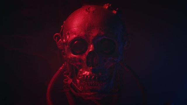 Robotic skull in red light with smoke