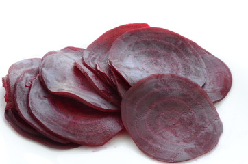 beautifully sliced beetroot stacked on top of each other, round slices of raw and healthy greenery full of vitamins and minerals, vegan and vegetarian healthy food, white background