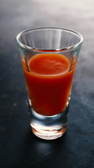 Vodka with tomato juice on a dark background