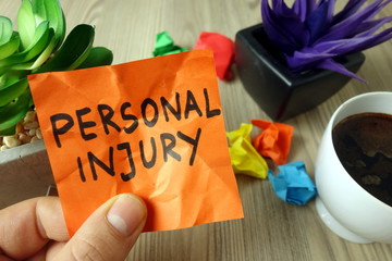 Text personal injury handwritten on sticky note