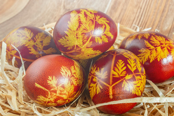 Easter painted eggs in straw close up