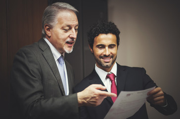 Businessman showing a document to his colleague