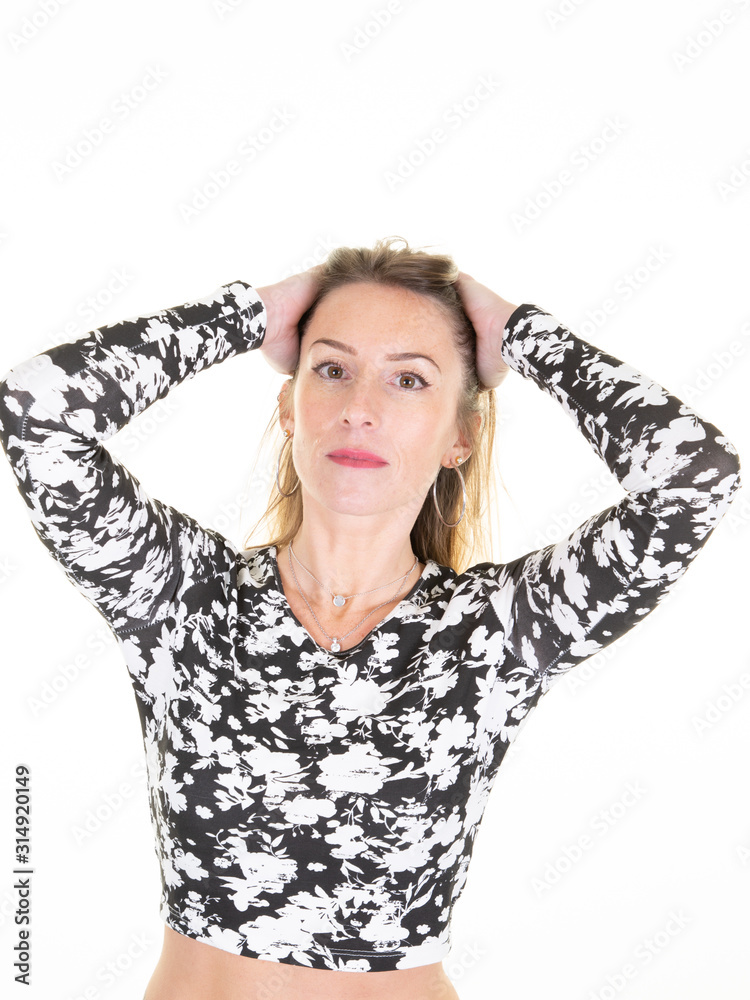 Wall mural cheerful woman in fashion t-shirt touching hair in white background