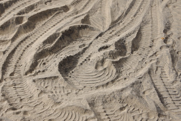 Fototapeta na wymiar Full frame close-up view of vehicle tracks in the beach sand