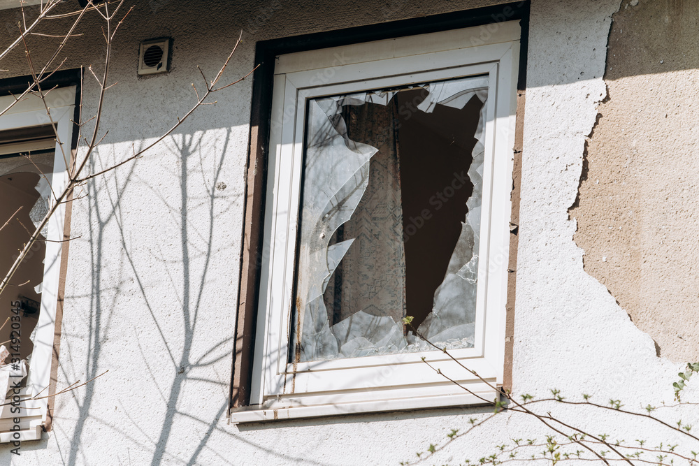 Wall mural Broken Windows in the house. Shards of glass remained in the window.