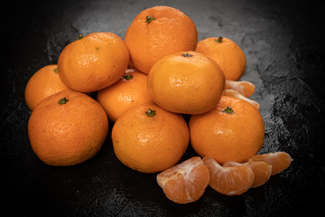Mandarines, tangerine, clementine on black background