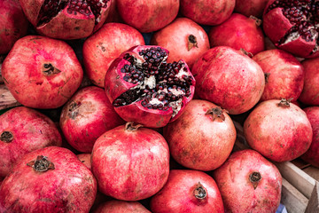 Red pomegranate fruit at street market. Group of pomegranates