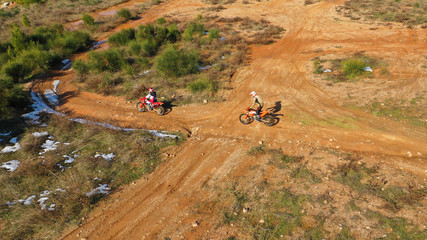Aerial drone of moto cross dirt bike in compete in dirt track