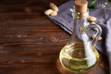 Healthy Peanut oil in glass bottle. Dark wooden background Copy space