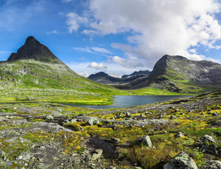 Lake among the stone peaks and mossy landscape of Alnesvatnet Norway