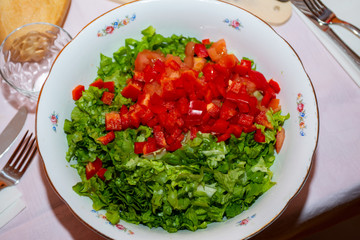 salad bowl in the foreground on a laid table