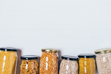 Top view glass jars with variety groats and pasta