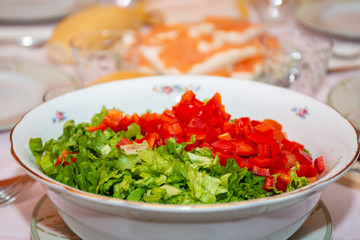 salad bowl in the foreground on a laid table