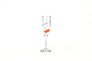 Glass of water filled with heart shaped candy