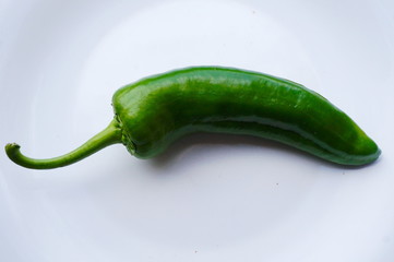 green chili pepper on black background
