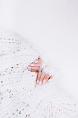 Stylish trendy white manicure. Tender female hands.