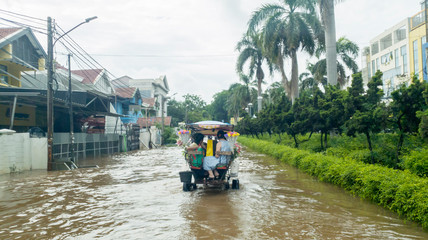 Horse cart with passengers crossing the flood