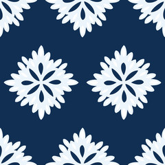 Abstract floral seamless repeat pattern in navy blue and white. Simple pattern of very light blue and white flowers on a navy blue background. Colors coordinate with color of the year Classic Blue.