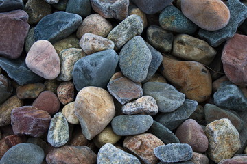 Multi-colored stones in the frost covered with hoarfrost