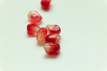 Red pomegranate seeds, white background. Mono Shooting. Juicy bright red fruit. Love.