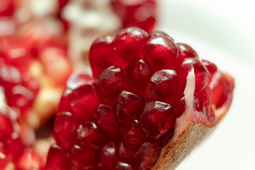 Red pomegranate seeds, white background. Mono Shooting. Juicy bright red fruit. Love.