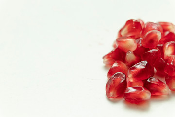 Red pomegranate seeds, white background. Mono Shooting. Juicy bright red fruit. Love.