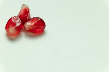 Red pomegranate seeds, white background. Mono Shooting. Juicy bright red fruit. Love.