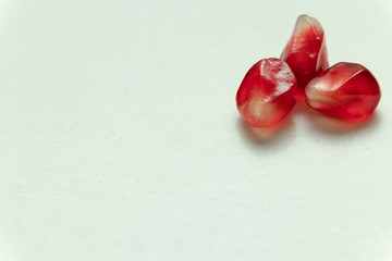 Red pomegranate seeds, white background. Mono Shooting. Juicy bright red fruit. Love.