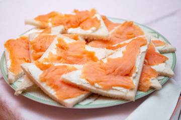 salmon canapes in the foreground on a laid table