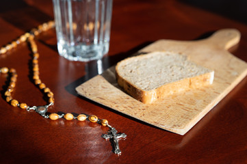 bread and water lent before easter with rosary beads .