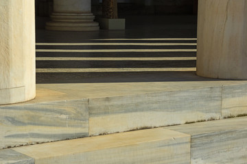 Fototapeta na wymiar elements of marble columns and steps along with shadows on a sunny day