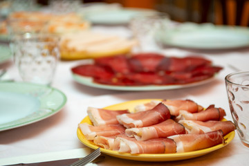 ham and cold cuts on a laid table