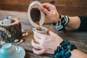 woman hold the mug and telling fortune with traditional turkish coffee cup.