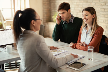 Young couple having a meeting with insurance agent in the office.