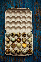 a small quail egg, on a blue, wooden,old, shabby background