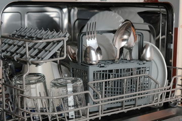 Dishwasher close-up, clean dishes after washing, household appliances for the kitchen