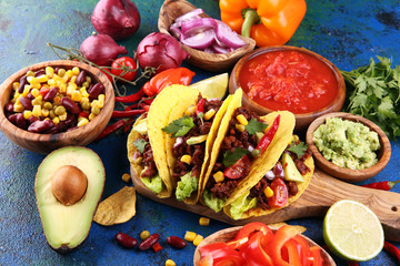 Mexican tacos with beef, tomatoes, avocado, chilli and onions. Handmade tortilla with pork