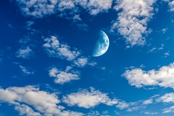 Half moon in blue sky during the day 