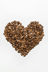  Heart laid out from coffee beans on a white background