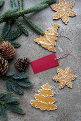 Christmas copy space background with gingerbread, fir tree branch, cone and greeting card