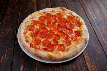 tasty pizza on the wooden background